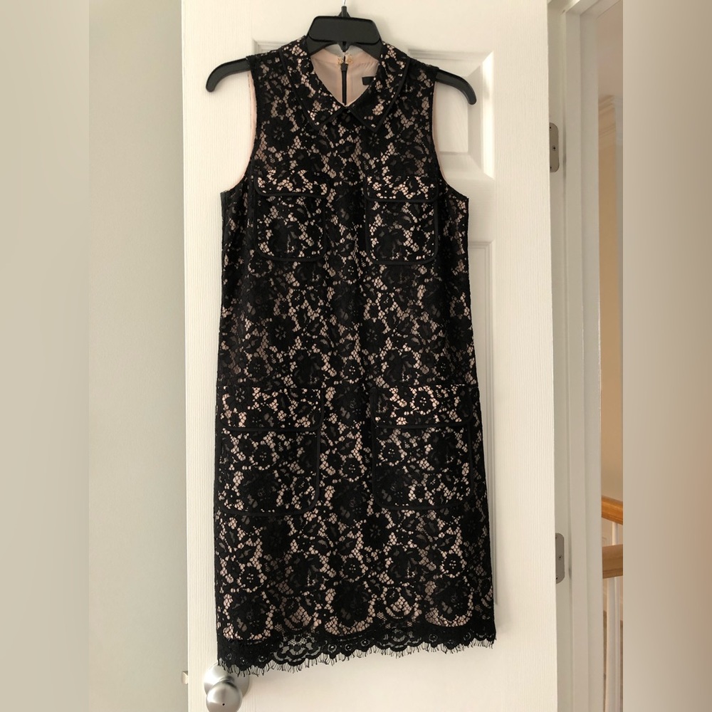 Black lace shift dress with front pockets.